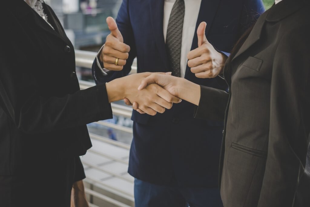 business-people-shaking-hands-finishing-up-meeting-deals-business-concept Business handshake after successful meeting